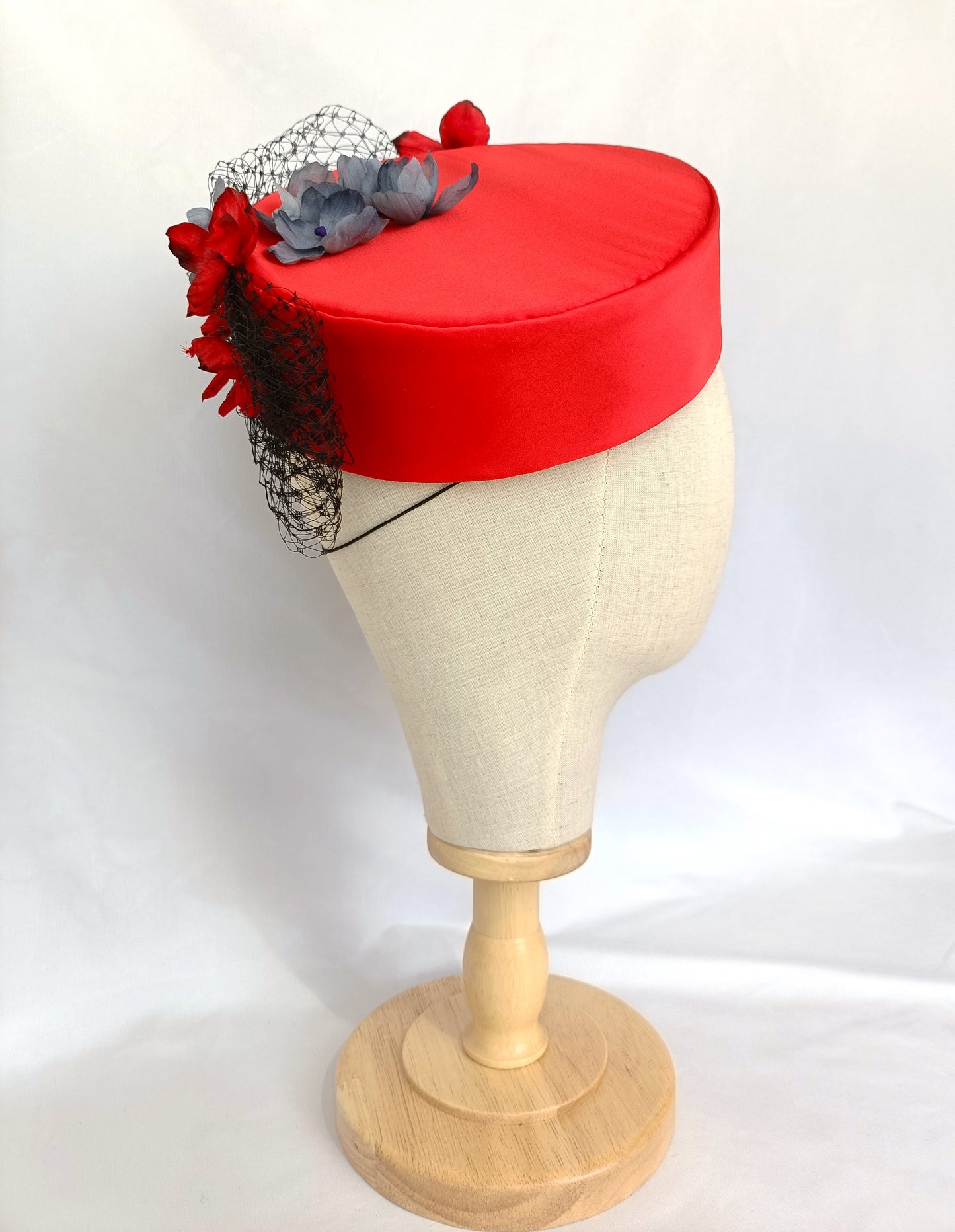 Tocado pillbox rojo de seda con flores artesanales.