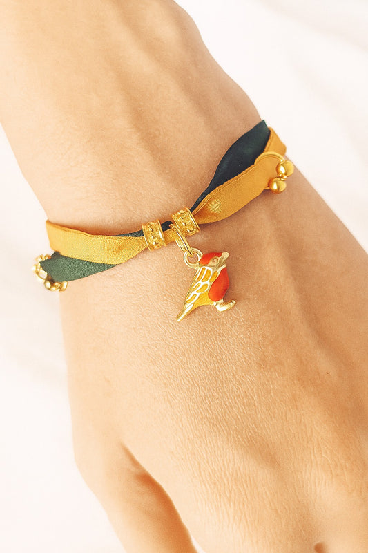 Pulsera de seda verde y mostaza con pajarita esmaltada