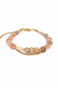 Pulsera de piedra del sol con cadenas doradas.