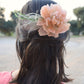 Headdress with dahlia and feathers.