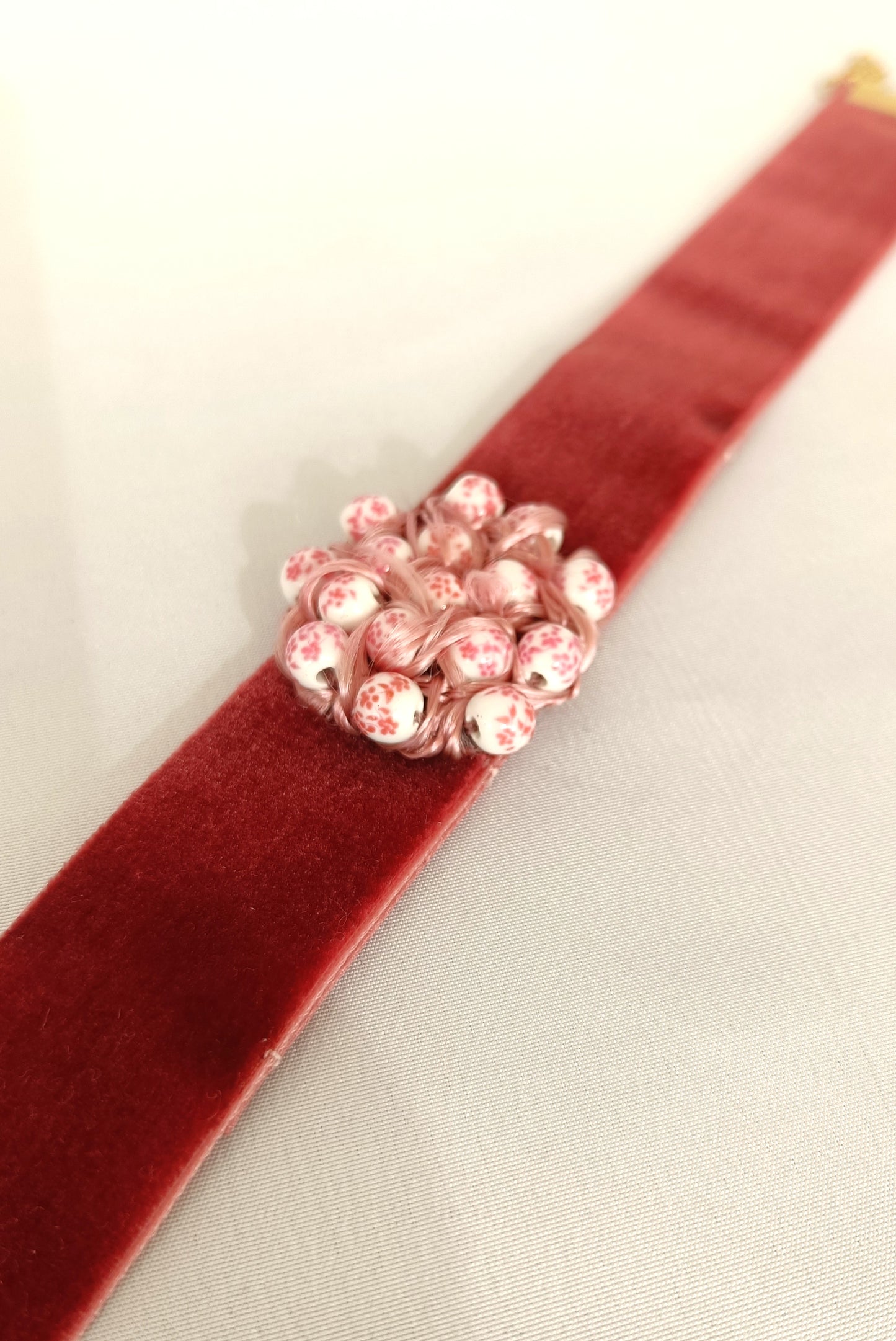 Choker rosa palo con detalle entrelazado.