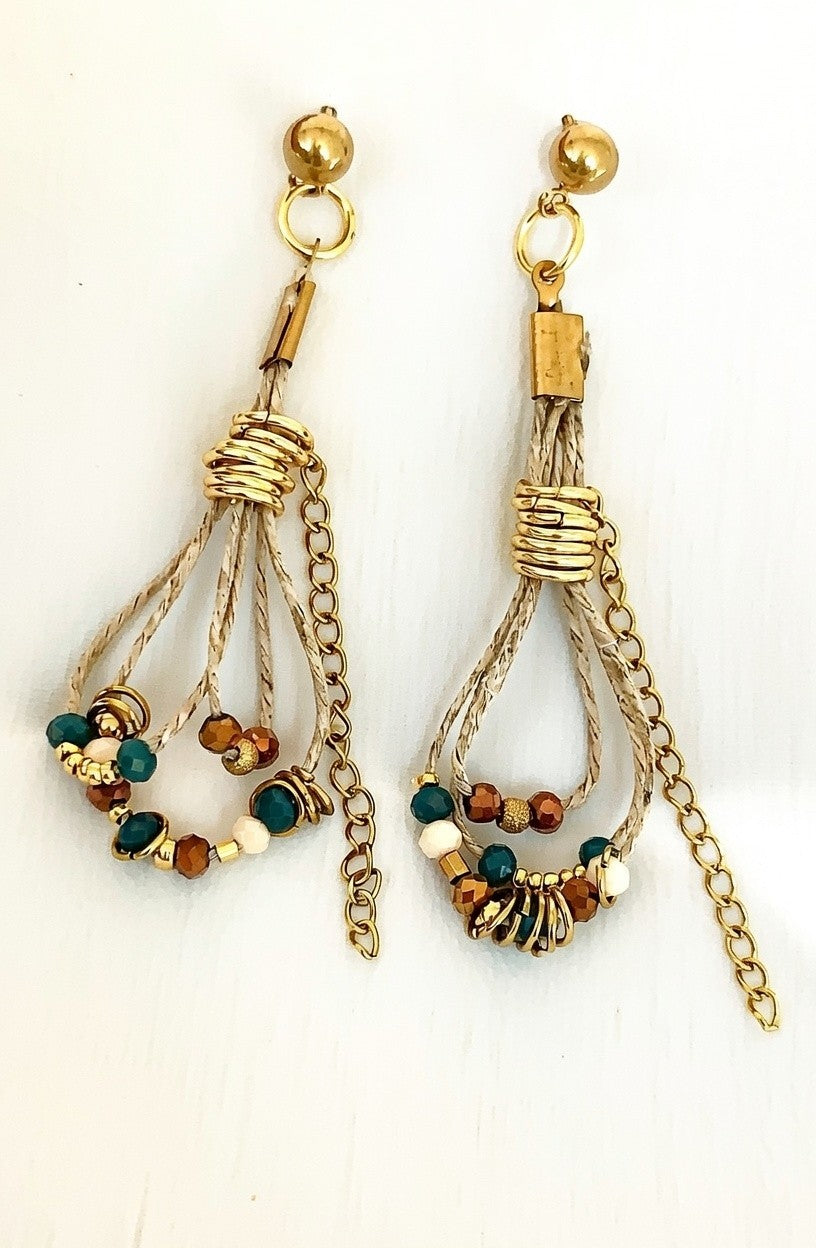 Pendientes de hilo de lino con cuentas en tonos azul y dorado.