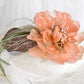 Headdress with dahlia and feathers.