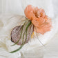 Headdress with dahlia and feathers.