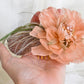 Headdress with dahlia and feathers.